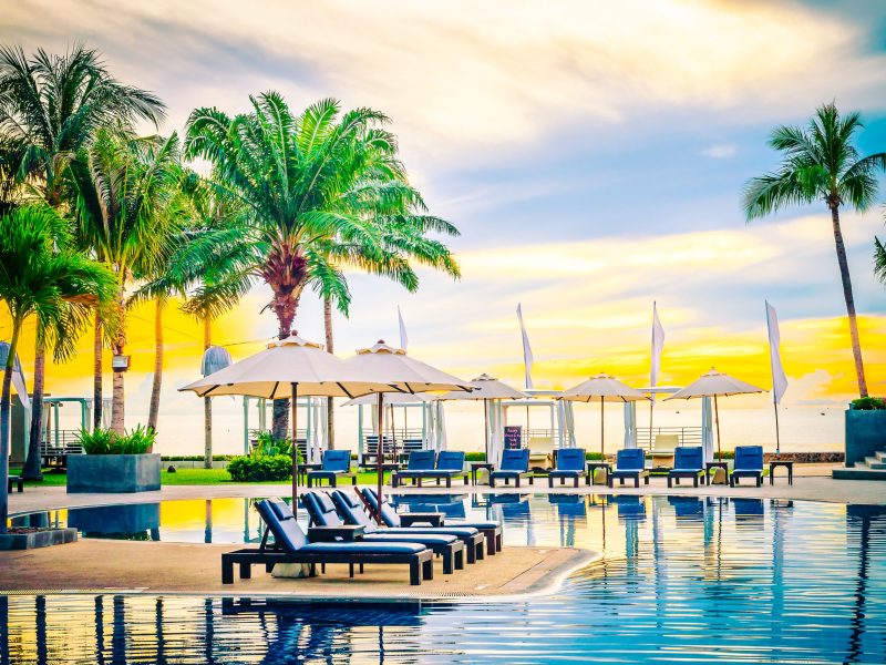 Umbrella in the luxury hotel pool resort at sunrise times - Vintage filter processing style pictures